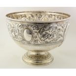 Silver repousse punch bowl, decorated in scrolling foilage and with blank cartouches. Hallmarked