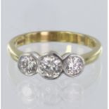 18ct three stone ring consisting of central round brilliant cut diamond calculated as weighing