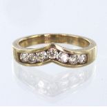 9ct yellow gold wishbone shaped ring, channel set with seven round brilliant cut diamonds weighing