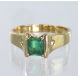 14ct yellow gold ring set with a rectangular step cut emerald measuring approx. 6mm x 5mm, with a