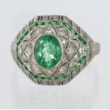 Platinum Art Deco style dome shaped dress ring set with a central oval emerald weighing 0.92ct,