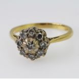 18ct and platinum cluster ring set with nine round brilliant cut diamonds totalling approx. 0.