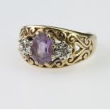 9ct yellow gold band ring set with a central oval amethyst measuring approx. 8mm x 6mm and with a