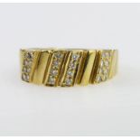18ct yellow gold band ring with diagonal sectional design, some set with pave set diamonds. Total