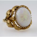 18ct yellow gold dress ring set with single oval opal cabochon measuring approx. 15mm x 12mm in a