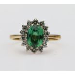 18ct yellow gold cluster ring featuring an oval green tourmaline measuring approx. 8.5mm x 6.5mm,