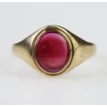 9ct yellow gold signet ring set with an oval red stone measuring approx. 9mm x 7mm, finger size R,