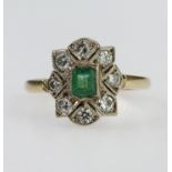 18ct yellow gold cluster ring set with rectangular central step cut emerald ? surrounded by eight