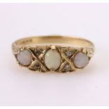 9ct yellow gold carved head ring set with central oval opal cabochon measuring approx. 5mm x 4mm,
