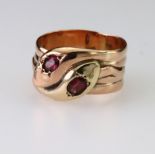 9ct double snake ring featuring a yellow and a rose gold snake with almandine garnet heads, finger