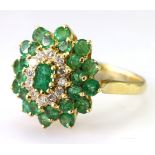 18ct yellow gold emerald cluster ring set with a central oval emerald measuring approx. 5mm x 3.5mm,