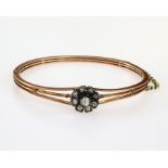 9ct rose gold hinged wire bangle with box clasp and safety chain. The floral cluster is a later