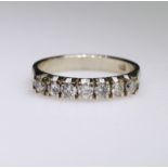 18ct white gold half eternity ring set with seven round brilliant cut diamonds weighing a total of