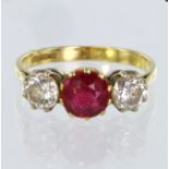 18ct yellow gold three stone ring set with central round mixed cut synthetic ? ruby, bordered on