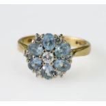 18ct yellow gold cluster ring set with six oval aquamarine measuring approx. 4mm x 3mm around a