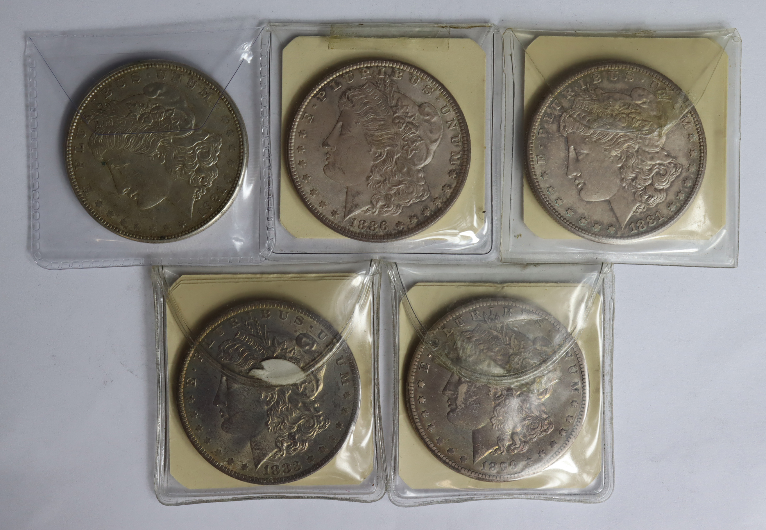 USA Morgan Silver Dollars (5): 1881S lightly toned UNC, 1883O similar, 1886 AU, 1899O VF, and