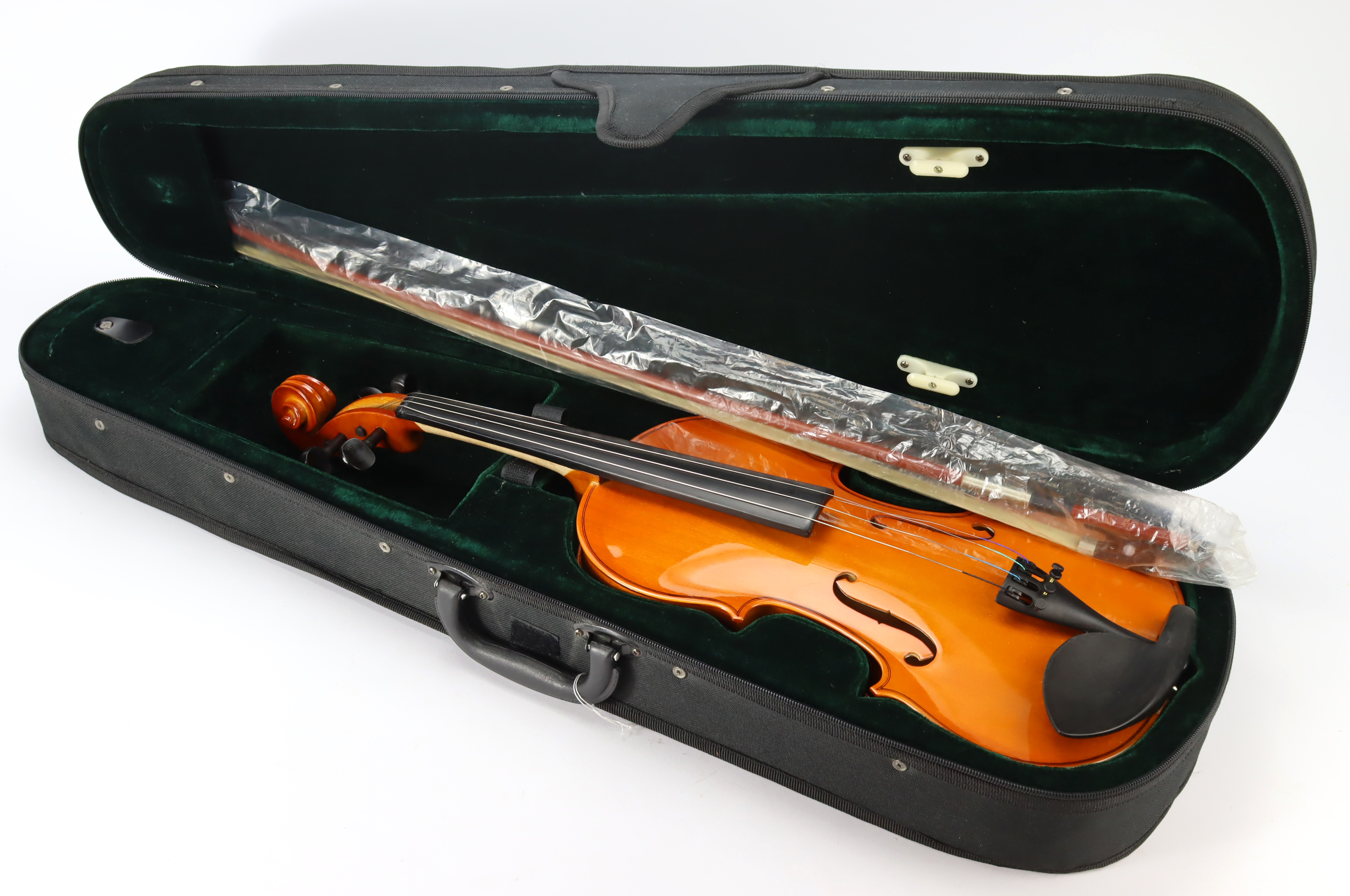 Violin (unnamed), length 37cm approx.(including button), with a bow, contained in a carrying case