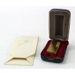 Dunhill gold plated lighter, contained in original case, together with a Chinese gold plated