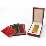 Must de Cartier gold plated lighter, with booklets, contained in original case