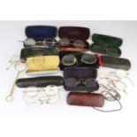 An assortment of various old spectacles in a tub