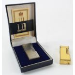 Two Dunhill lighters, consisting a yellow enamel example & a silver plated example contained in