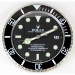 Advertising Wall Clock. Black & chrome 'Rolex' styleadvertising wall clock, black dial reads '