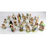 Beatrix Potter. A collection of thirty-two Beswick Beatrix Potter figures, circa mid 20th
