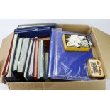 Large microwave box of various albums / stockbooks, stamps in tins and box, plastic tub of