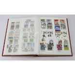 GB - red stockbook 1936 to c1990 um collection, mainly Commems and includes QE2 phosphor sets, Red