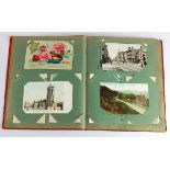 Original WW1 era postcard collection in red album, inc RP's and Regimental Silk cards