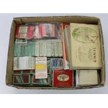 Blue cardboard tray of loose Cigarette Cards in packets etc, plus a few sets stuck in old albums. (