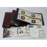 GB FDC's in 2x albums, various postmarks. Empty cover album. 22ct Golden Replicas of British Stamp