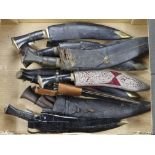 Kukri knives, several various types with scabbards, in a banana box. Two stamped on the blade 1)