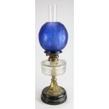 Oil Lamp. A brass based oil lamp, circa late Victorian, with inner glass tube & dark blue glass