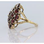 9ct yellow gold dress ring set with nine oval garnets spaced by round cz, finger size Q, weight 4.