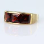 9ct yellow gold band ring set with three princess cut garnets