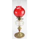 Oil Lamp. A brass based oil lamp, circa late Victorian, with inner glass tube & rich red glass