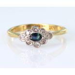 18ct yellow gold and platinum ring set with a central oval sapphire surrounded by eight round