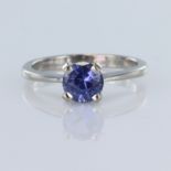 18ct white gold solitaire ring set with a round tanzanite measuring approx. 7mm diameter, finger