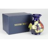 Moorcroft 'Hibiscus' Blue Vase by Walter Moorcroft. 1st quality, boxed. Height measures 13cm