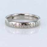 Platinum band ring with Roman numural decoration and four round brilliant cut diamonds spaced, total