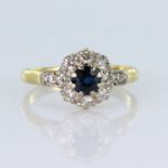 18ct yellow gold cluster ring comprising a central round sapphire measuring approx. 5mm,