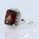 9ct white gold chequerboard cut garnet measuring appox. 10mm x 7mm, finger size N, weight 3.5g