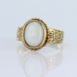 9ct yellow gold single stone ring set with an oval opal cabochon measuring approx. 10mm x 8mm,