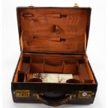 Crocodile skin suitcase. With brass lock plates and catches. With a leather lined interior