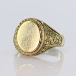 9ct yellow gold signet ring with oval head measuring approx. 14mm x 11mm with scroll decoration to