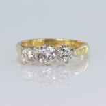 18ct yellow gold trilogy ring set with three graduated round brilliant cut diamonds, centre