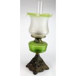 Oil Lamp. An iron based oil lamp, circa late Victorian, with inner glass tube & frosted green