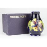 Moorcroft 'Hibiscus' Blue Vase. 1st quality, boxed. Height measures 13cm