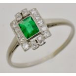 Platinum, Emerald and Diamond Cluster Ring, set with single baguette cut emerald (slightly chipped),